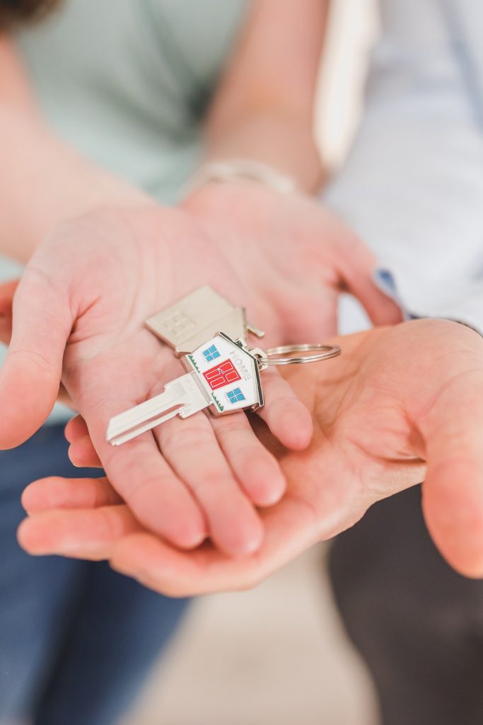 a key being hold by property investors